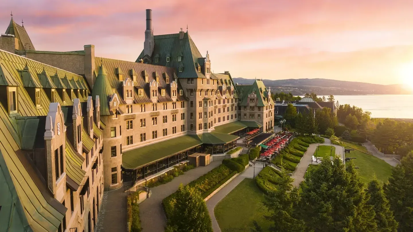 Historic resort façade beside open water